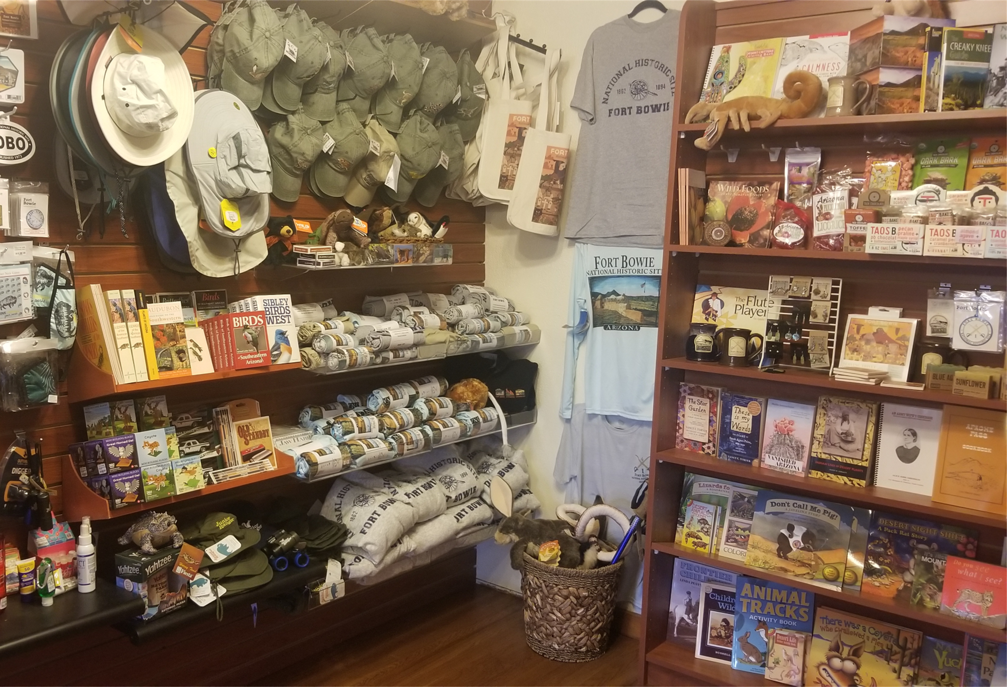 Books, shirts, and other store items are displayed on shelves.