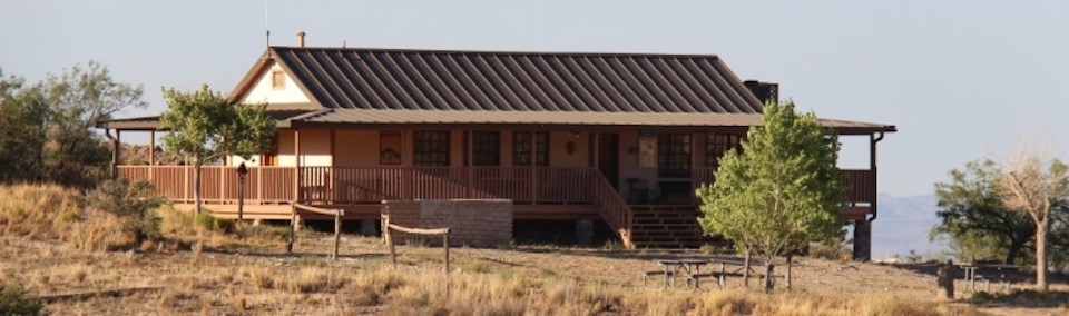 a low ranch house with wrap around porch