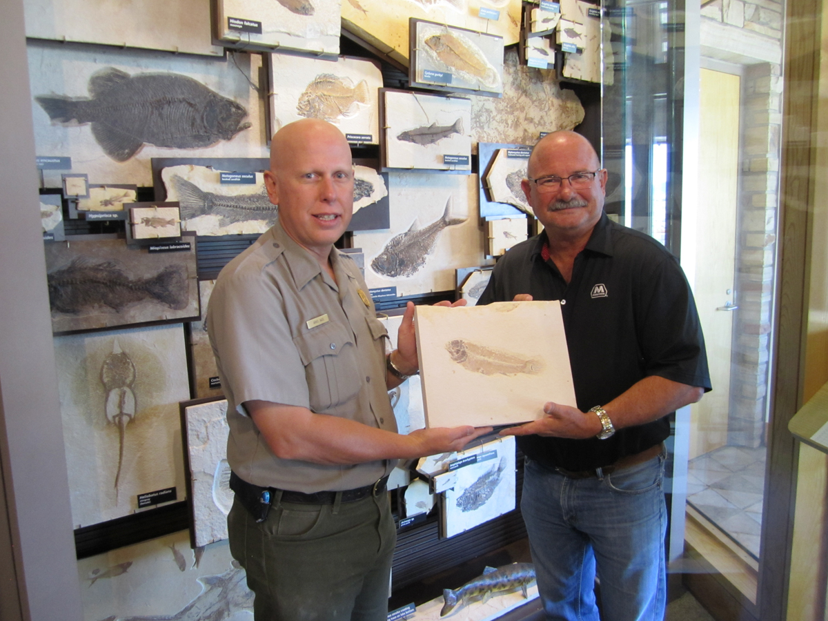 Arvid Aase and Philip Frasier hold fossil bowfin