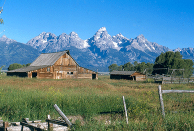 Barn with snow topped mountains in the background Barn with snow topped mountains in the background