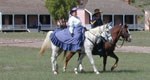 Lady and soldier on horseback.