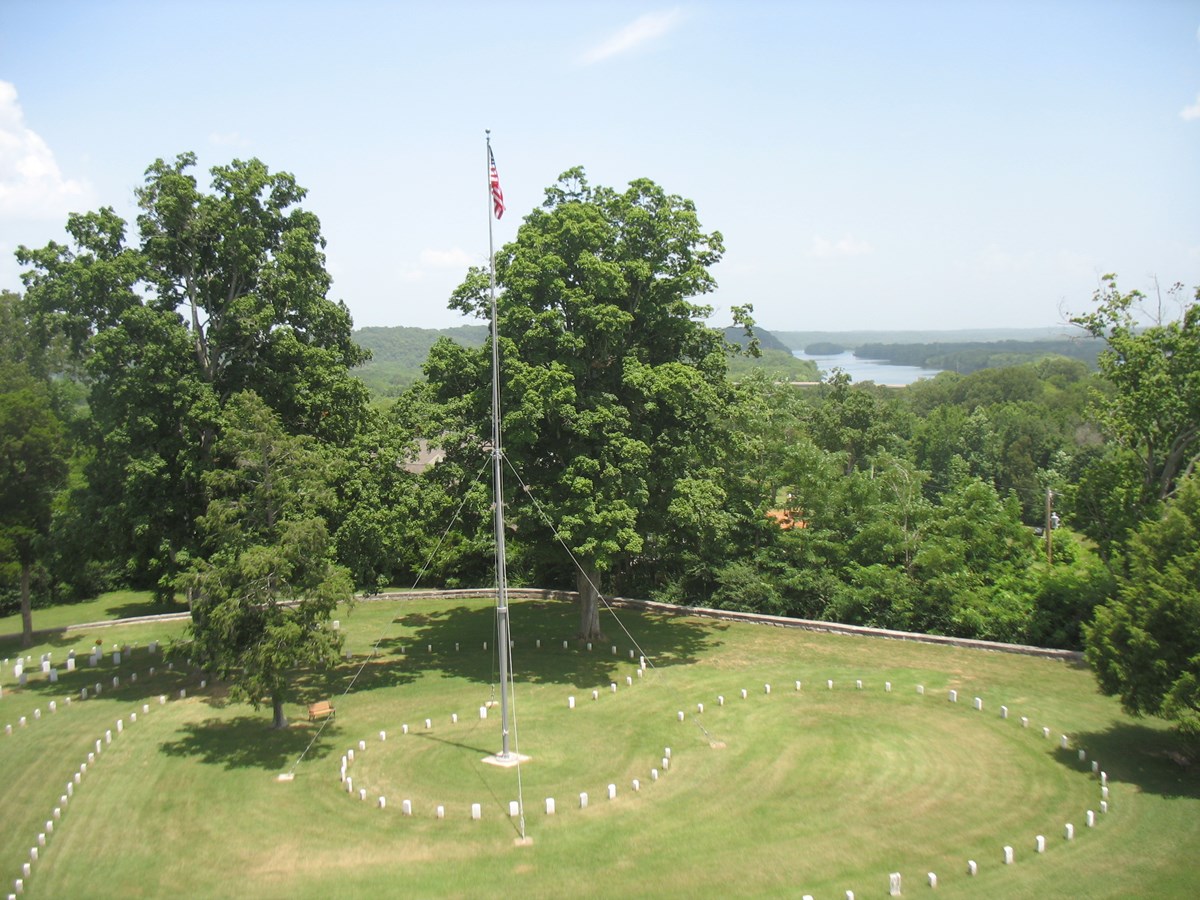 flagpole and cemetery headstones