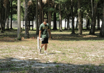 man walking with archeology equipment