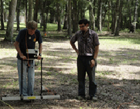 two men standing with archeology equipment