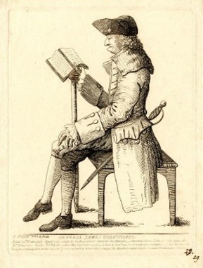 Man sitting in a chair reading a book.