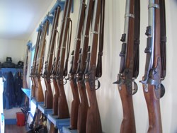 Reproduction 1866 Springfields in holders on the wall of the barracks.