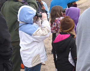 Young children with binoculars.