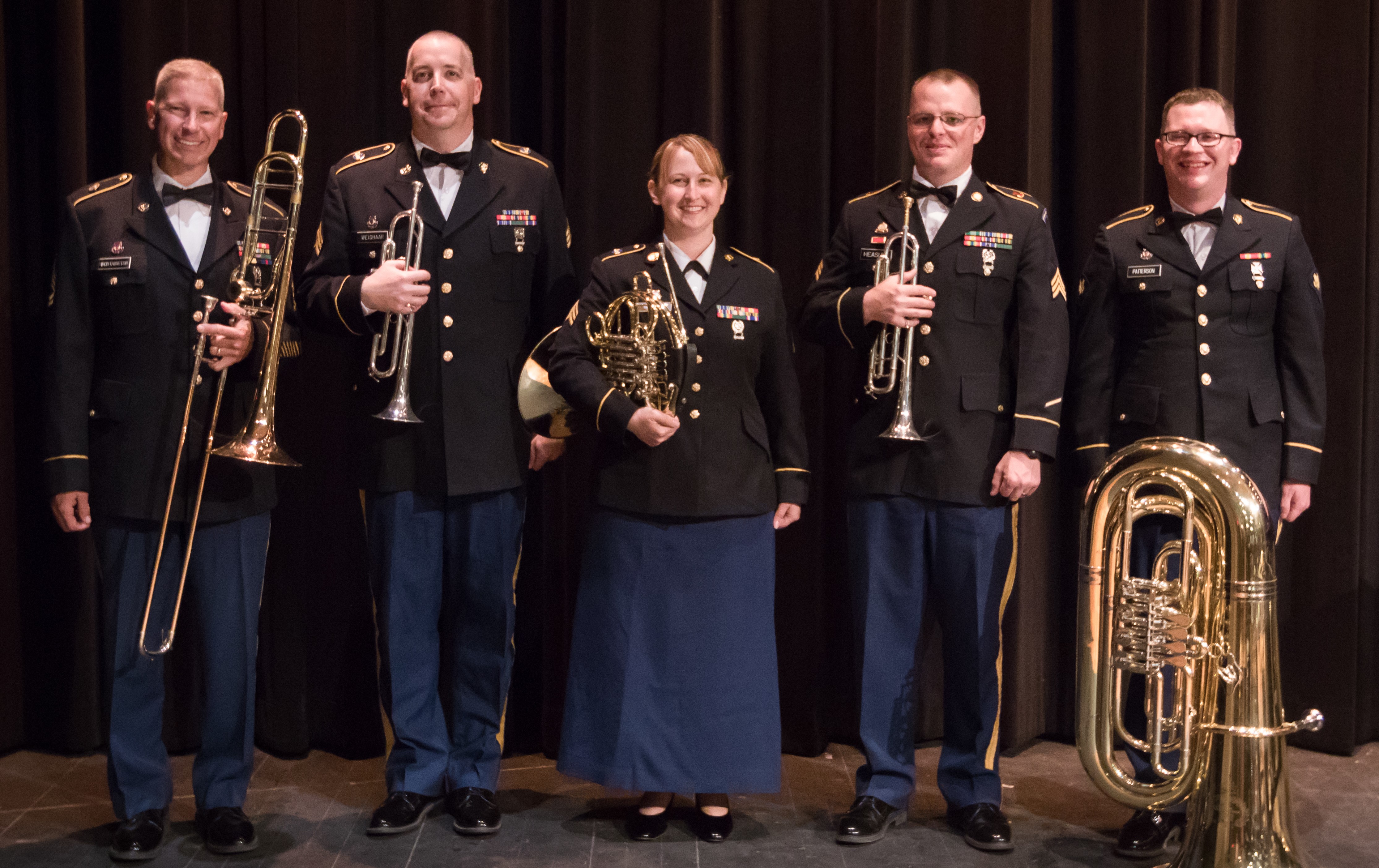Heartland Brass Quintet Five army soldiers with brass instruments on stage.