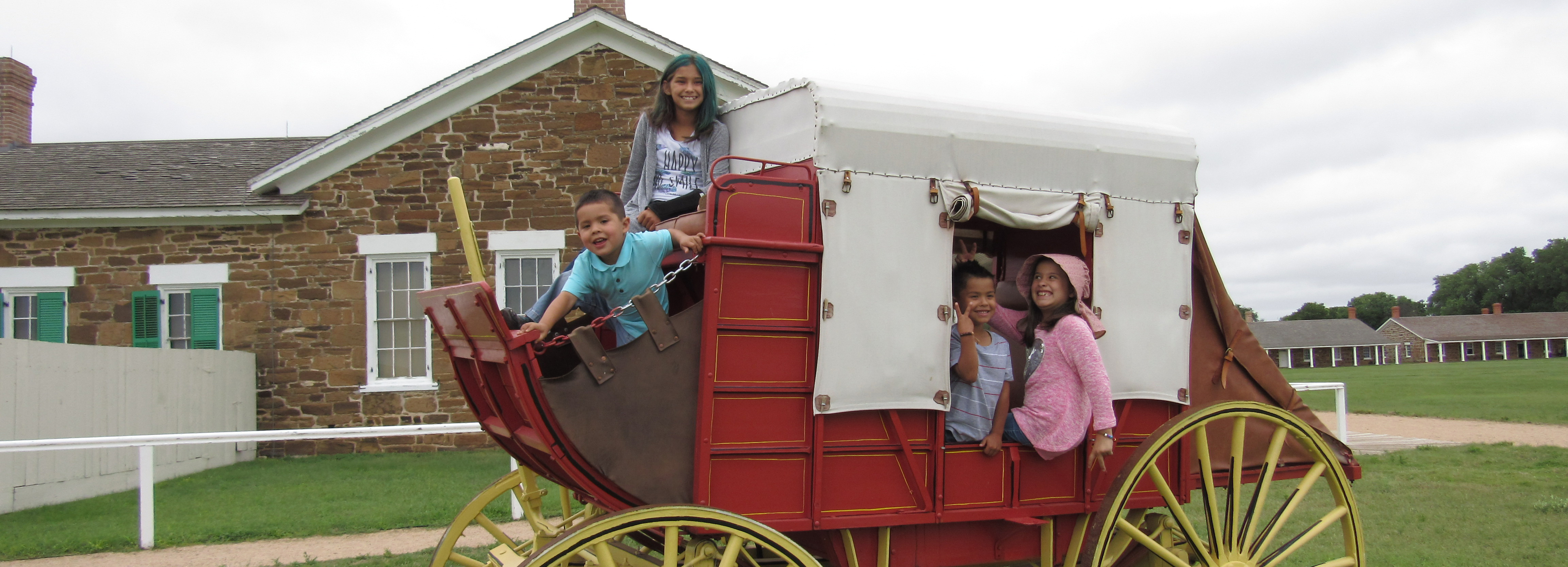 Children in a 1800s mail wagon.