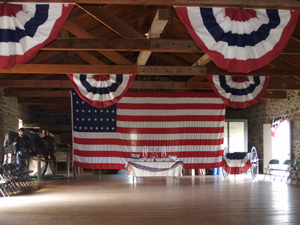 Historic warehouse with bunting and large flag hanging from rafters.