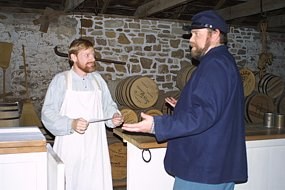 Photo of an Infantry Soldier talking to the Commissary Clerk.