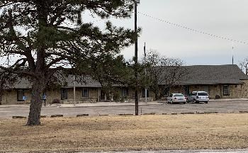 Image of building with trees in front.