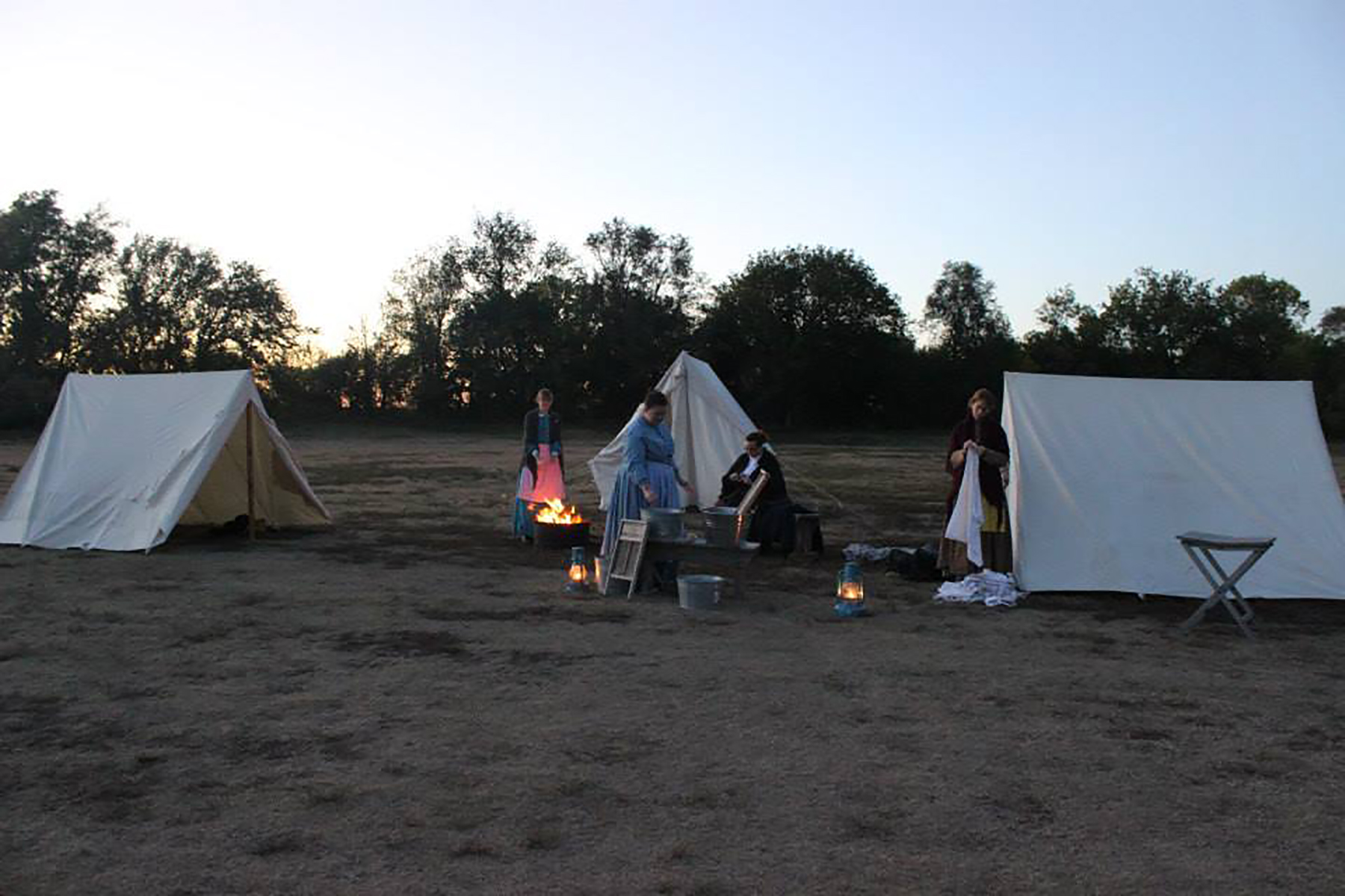 Photograph of 19th century laundress ren-enactor by tents. Photograph of 19th century laundress ren-enactor by tents.