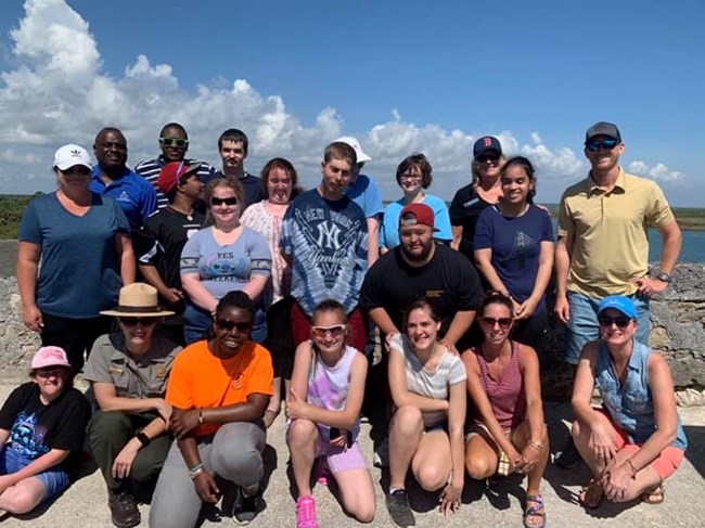 Group of students, two teachers, and a ranger on top of fort.