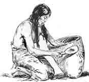 An Indian woman uses a carved paddle to decorate a pot. An Indian woman uses a carved paddle to decorate a pot.