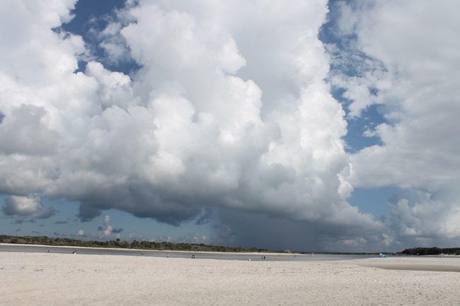 Cloudy sky with water and fort Matanzas and the beach
