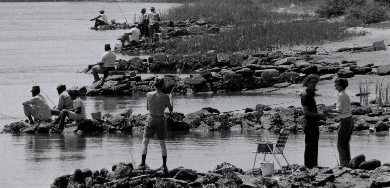 Locals fishing from the shoreline rocks