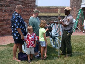 A Park Ranger gives an artillery talk to a few visitors.