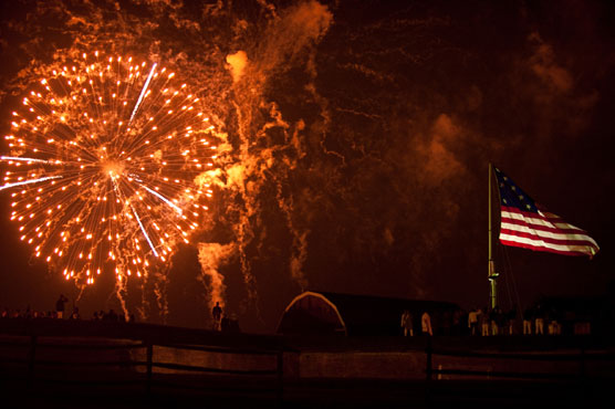 Fireworks illuminating the flag during The Star-Spangled Banner Weekend evening program.