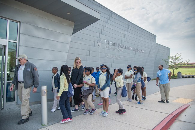 A school group walks into the park's visitor center.