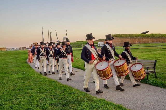 Living historians dressed as sea fencibles marching out of Fort McHenry.