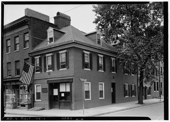 A historic black and white photo graph of the flag house.