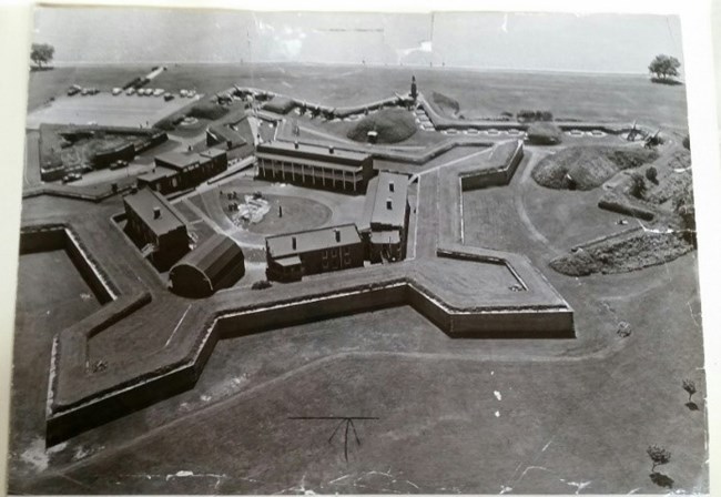 A black and white photograph showing Fort McHenry from the air.