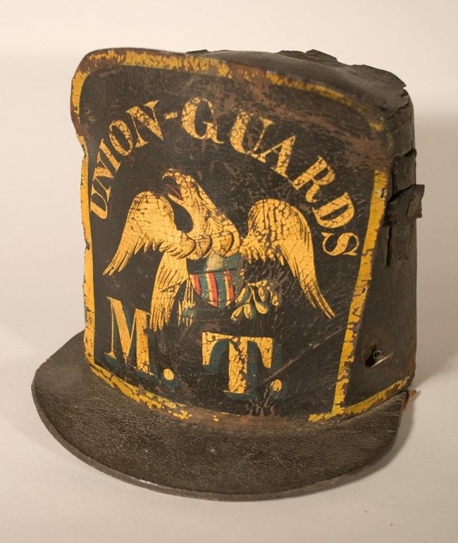 A photograph of a shako from the war of 1812 that has
