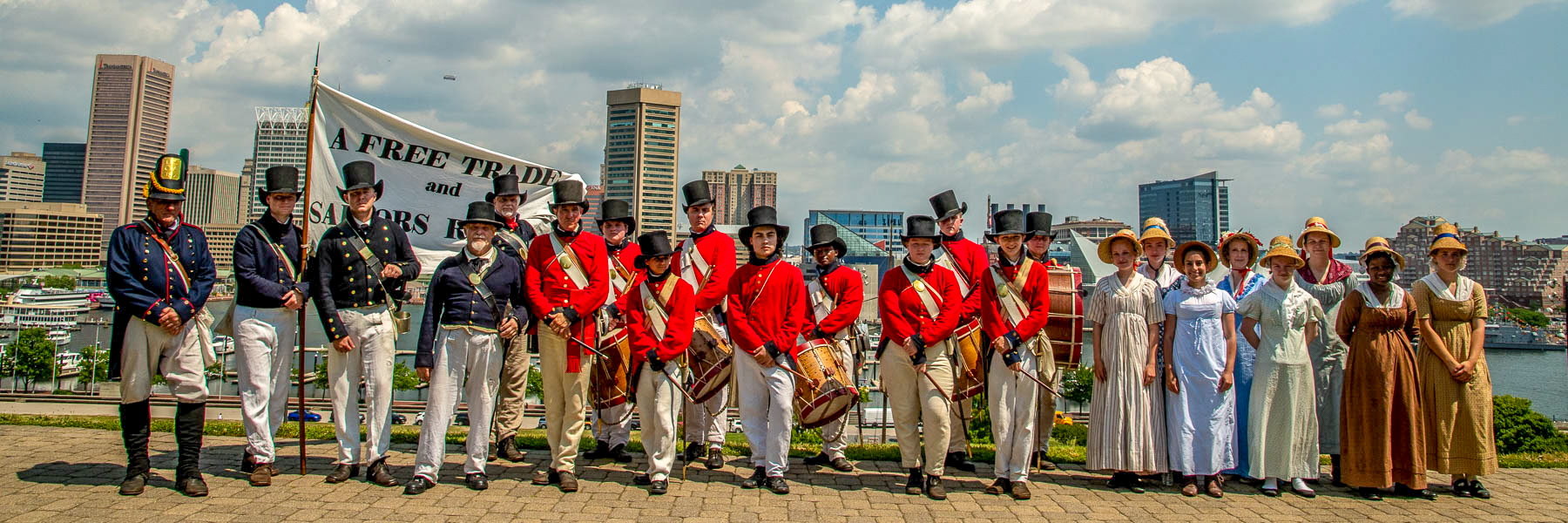 Fort McHenry Guard at Federal Hill Living historians in War of 1812 uniforms and dress with Baltimore skyline