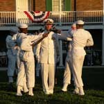 Group of five men in white navy uniforms.