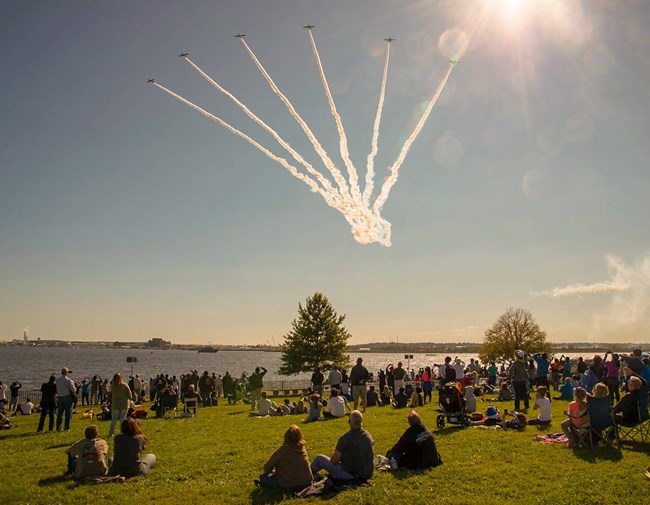 Airshow viewing area with planes in formation above
