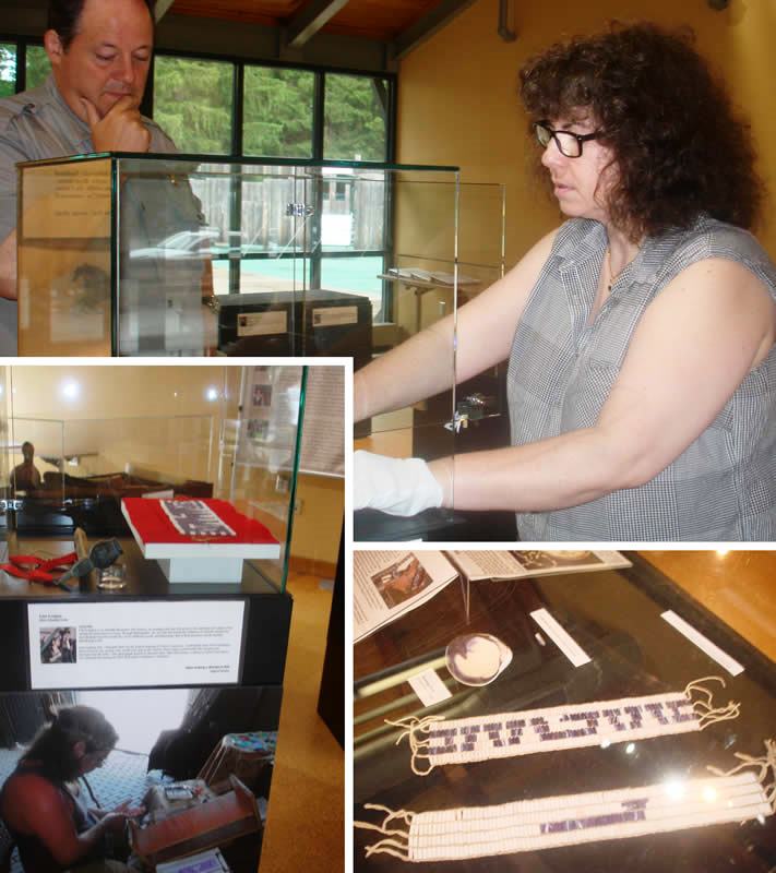 Vera Longtoe Sheehan of the Vermont Abenaki Artists Association and Park Ranger Brian Reedy install the exhibit "Parley and Protocol" at the Fort Necessity visitor center.