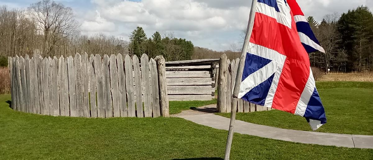 Fort Necessity with flag. Image of 18th Century British flag in front of fort.