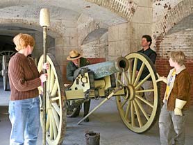 Canon loading demonstration showing ranger behind cannon and audience helpers Canon loading demonstration showing ranger behind cannon and audience helpers