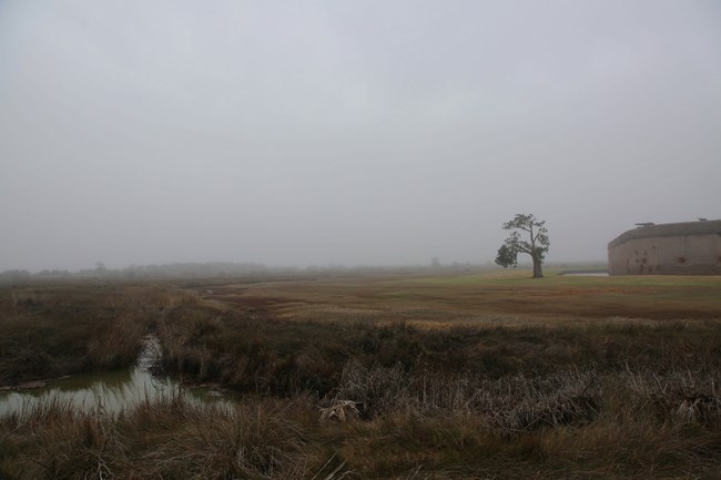 Foggy view of a ditch outside of the fort