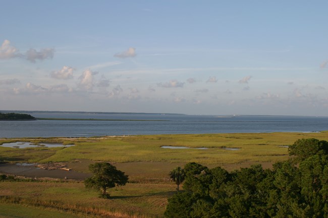 Aerial view of Fort Pulaski salt marshes and maritime forest with the Savannah River in the background