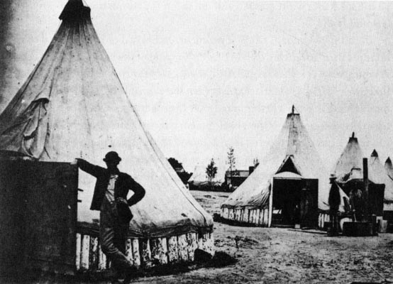 a black and white image of a couple tents set up in a row