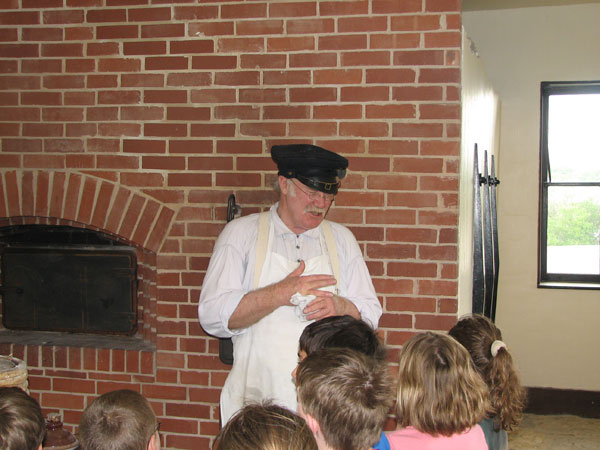 Volunteer portraying baker in education program