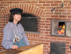 Baker in front of oven Baker in front of oven