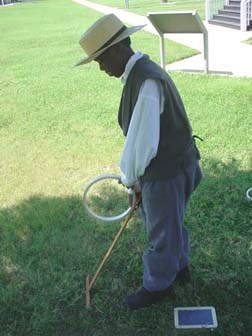 Child Playing with Hoop and Stick