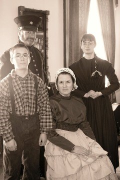 Reenactors portraying an officer, his wife and their children Reenactors portraying an officer, his wife and their children
