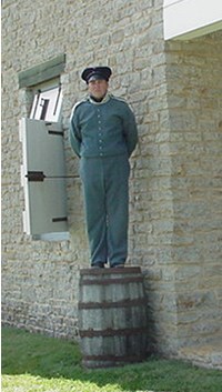 Punishment of standing at attention on
a barrel