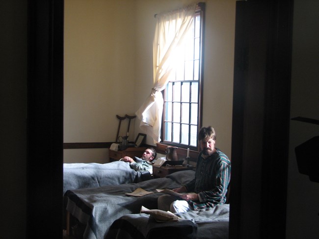 two men on hospital beds in a hospital room