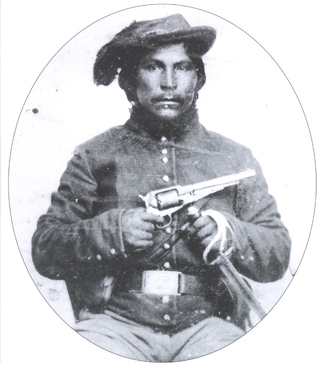 Native American in soldier uniform with Gun