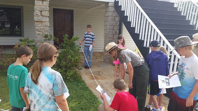 Park Ranger helps Trailblazers measure a stone walkway.