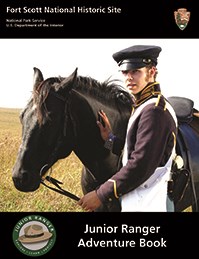 Photo on front of a Fort Scott Junior Ranger's book shows a young man in an 1840s soldiers field uniform holding the reigns of a black horse.