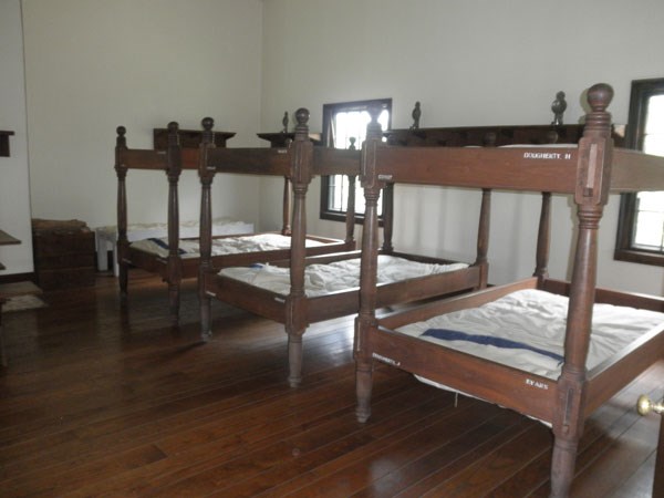 three wooden bunk beds