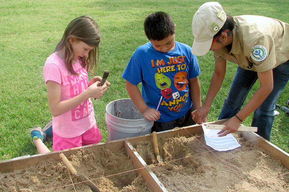 Youth Conservation Corps (YCC) intern teaching two students Youth Conservation Corps (YCC) intern teaching two students