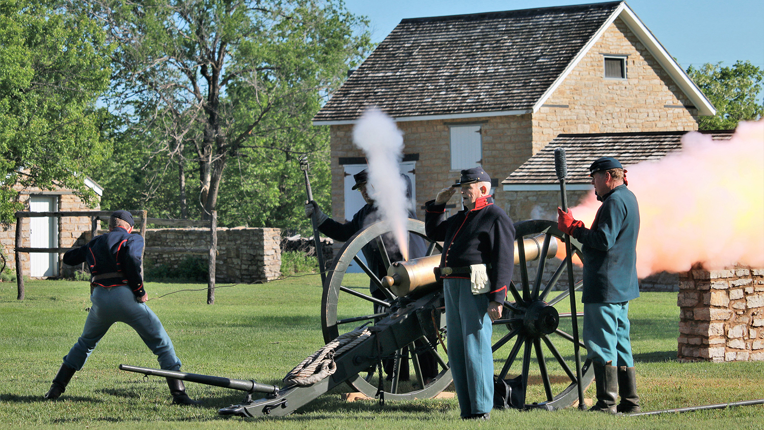 Four Union Solderer reenactors firing a canon. Four Union Solderer reenactors firing a canon.