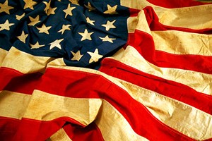 Picture of a older and worn flag with wrinkles.